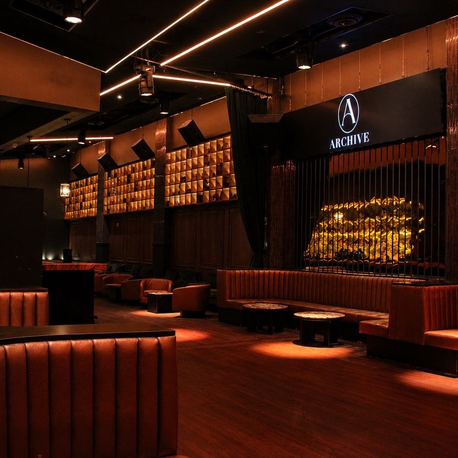 DJ booth and stage area with banquettes facing the floor